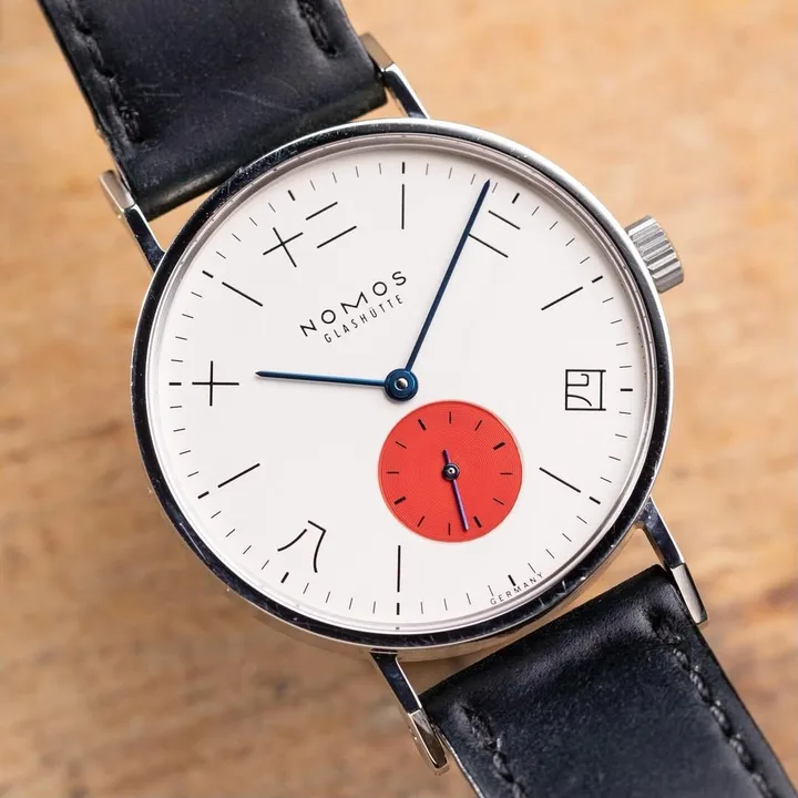 Tangente Toki with Japanese hour markers and a red small-seconds dial on a wooden surface